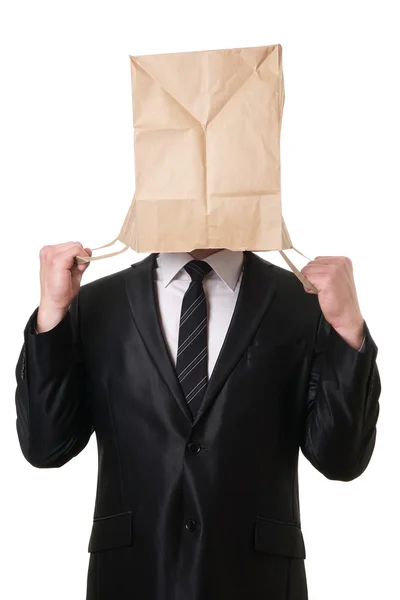 Businessman pulling paper bag over his head — Stock Photo, Image