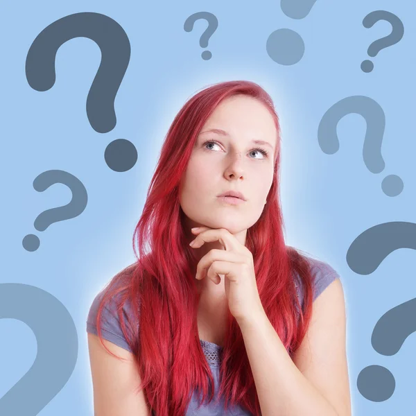 Pensive young woman with interrogation marks — Stock Photo, Image