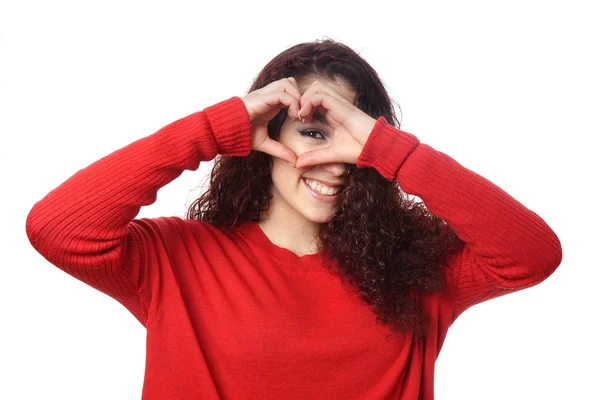 Kız kalp şekli el işareti ile bakmak — Stok fotoğraf
