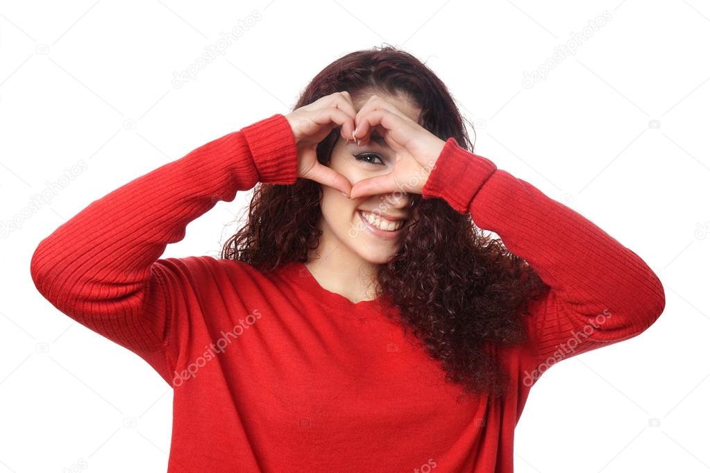 girl peeking through heart shape hand sign