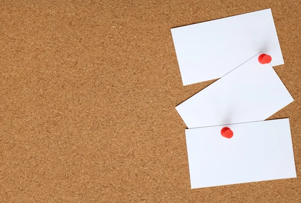 Cork board with three white cards pinned to it — Stock Photo, Image