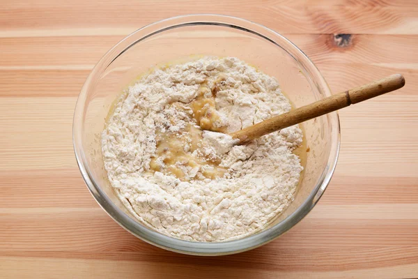 Flour being stirred into batter for banana bread — Stock Photo, Image