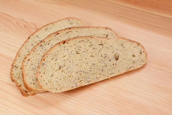 Three slices of bread on a wooden table — Stock Photo, Image