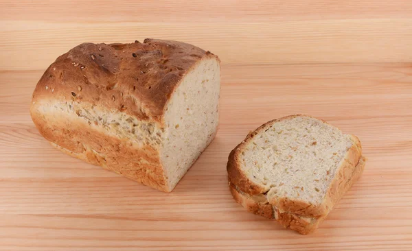 Cut loaf of freshly baked bread with a PB&J sandwich — Stock Photo, Image