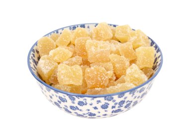 Crystallised stem ginger in a blue and white china bowl clipart