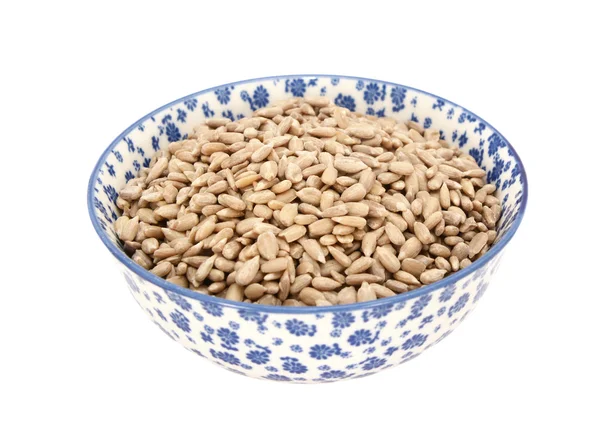 Sunflower seed hearts in a blue and white china bowl — Stock Photo, Image