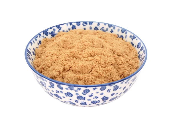 Light muscovado sugar in a blue and white china bowl — Stock Photo, Image