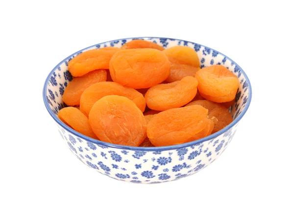 Dried apricots in a blue and white china bowl — Stock Photo, Image