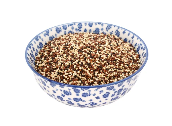 Mixed red, white and black quinoa in a blue and white china bowl — Stock Photo, Image