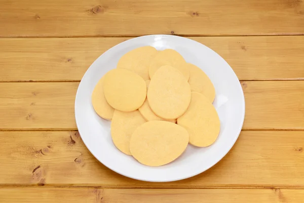 Pile of egg-shaped biscuits on a white plate — Stock Photo, Image