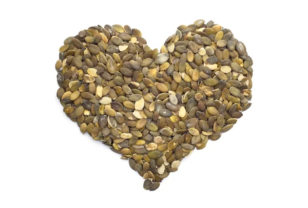 Pumpkin seeds in a heart shape — Stock Photo, Image