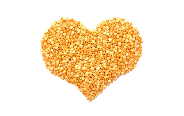 Yellow split peas in a heart shape — Stock Photo, Image