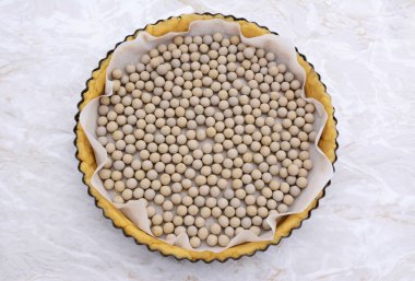 Ceramic beans in an uncooked pie crust clipart