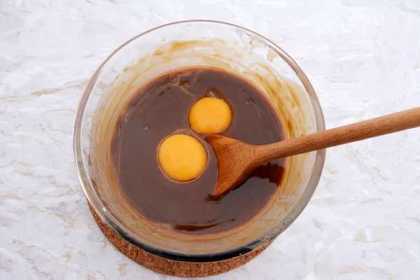 Stirring egg yolks into pecan pie filling — Stock Photo, Image