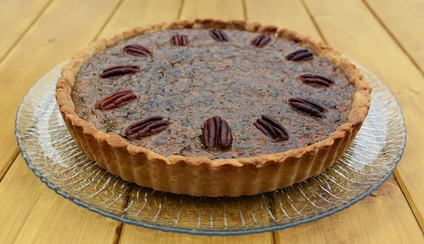 Freshly baked pecan pie on a glass plate — Stock Photo, Image