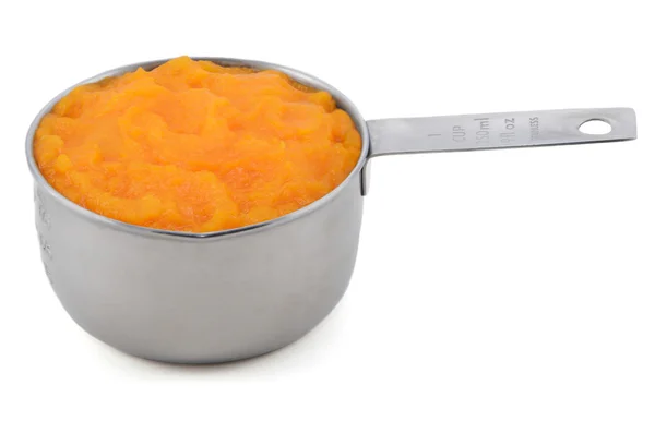 Pureed pumpkin in a measuring cup — Stock Photo, Image