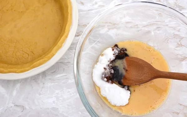 Stirring sugar into beaten egg for pumpkin pie filling — Stock Photo, Image