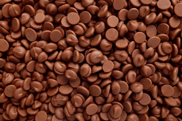 Milk chocolate chips background — Stock Photo, Image