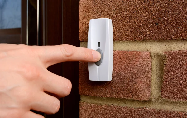 Close-up of woman pressing a doorbell — Stock Photo, Image