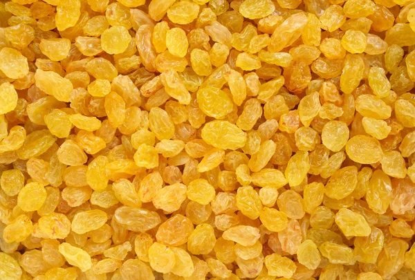 Golden raisins background — Stock Photo, Image