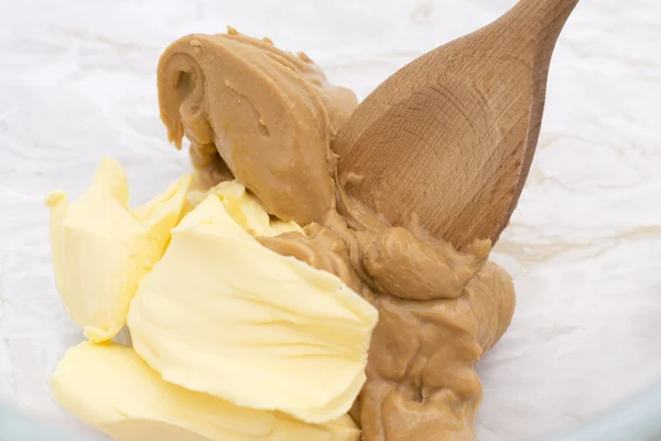 Mixing pats of butter and peanut butter — Stock Photo, Image