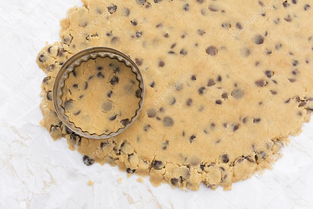 Cookie cutter on rolled out chocolate chip cookie dough