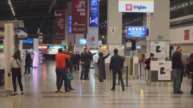 Skopje, Macedonia - 26 Oct, 2019: Tourist people travelers moving in aerodrome hall in Skopje, Macedonia
