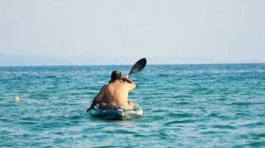 Halkidiki, Yunanistan - 25 Haziran 2018: Aile denizde kürek çeken bir teknede eğleniyor