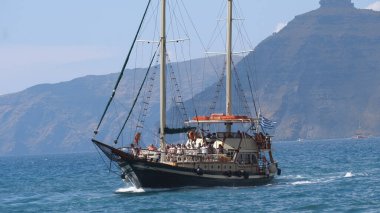 Oia, Santorini, Greece - 25 May, 2019: Old wooden Sailing ship tourist tour to the Santorini Volcano