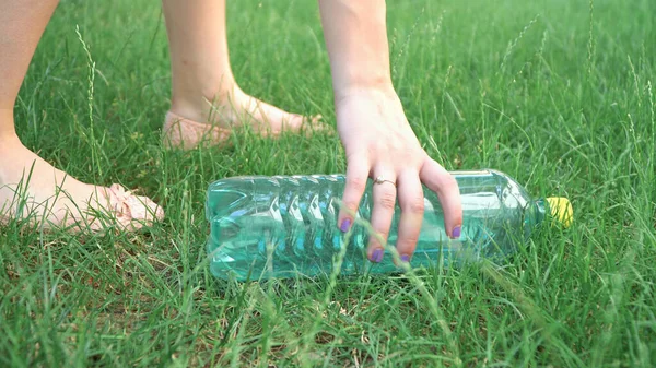 Girl volunteer help to keep nature clean up and pick up garbage in grass lawn