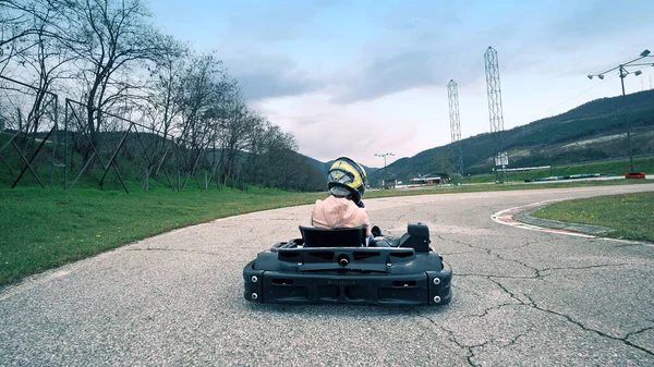 Drivers on leisure go-cart car on karting lap race extreme sport action