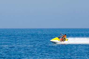Jet Ski sürüşündeki genç çift Tropikal Okyanus, Tatil Konsepti