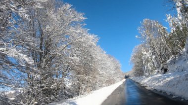 Kış mevsiminde kar yağarken karla kaplı bir yolun manzarası - Pov, ilk kişi