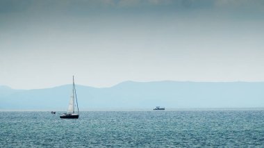 Ohri Gölü 'nde beyaz yelkenli yelkenli yelkenliyle yelken açan yat yarışı.