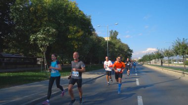 Üsküp, Makedonya - 06 Ekim 2019: Sporcular koşu maratonunda sokakta koşuyorlar
