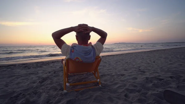 Задняя Часть Человека Кресле Руками Головой Зонтиком Пляже Видом Закат — стоковое фото