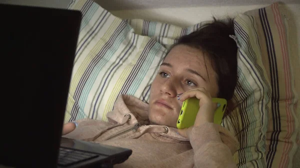 Ευτυχισμένο Έφηβο Κορίτσι Φορητό Υπολογιστή Στο Κρεβάτι Κουβεντιάζοντας Στο Τηλέφωνο — Φωτογραφία Αρχείου
