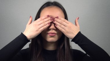 Utangaç, baştan çıkarıcı kız kameraya bakıp gülümsüyor.