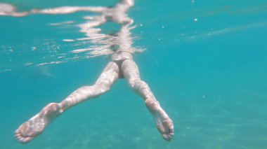 Deniz turkuazında temiz suda yüzen iki seksi manken. Su altı veiw