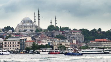 Istanbul, Turkey - 14 Mar, 2020: View of the Suleymaniye Mosque and fishing boats in Eminonu, Istanbul, Turkey