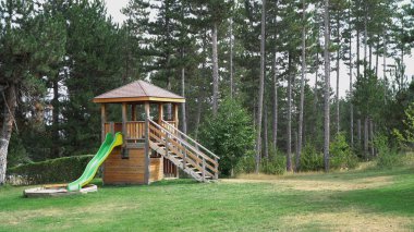 Ormanda kaydırağı olan çocuk parkı.