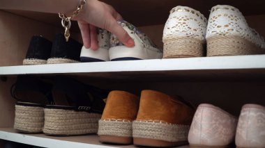 Woman take her favorite pair of summer shoes