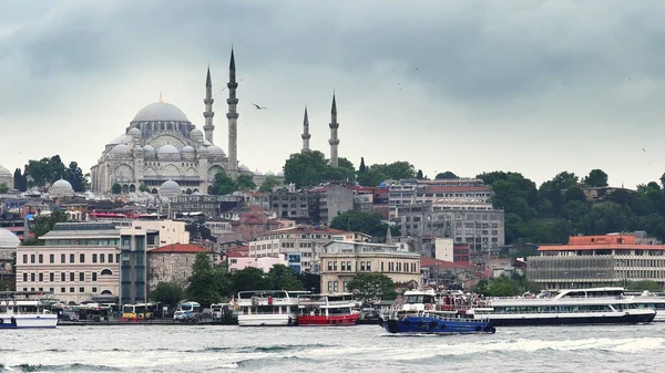 Istanbul, Turkey - 14 Mar, 2020: View of the Suleymaniye Mosque and fishing boats in Eminonu, Istanbul, Turkey