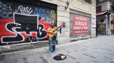 Istanbul, Turkey - 14 Mar, 2020: South american Inca street guitarplayer musician playing the guitar on Istiklal street ini Istanbul, Turkey