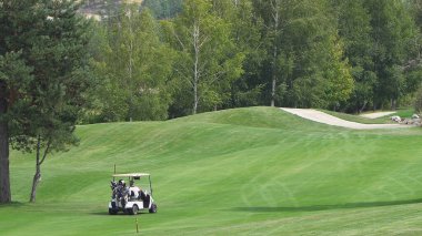 Bansko, Bulgaria - 12 Sep, 2019: Couple in buggy in golf course