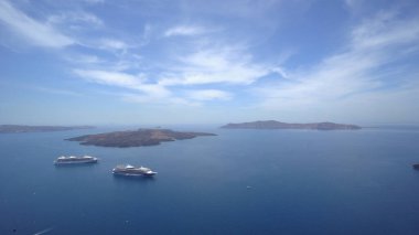 Yunanistan 'ın Santorini adasında, Thira' da seyahat gemileriyle panoramik manzara, arka planda Kameni volkanı adası