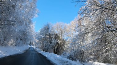 Kış mevsiminde kar yağarken karla kaplı bir yolun manzarası - Pov, ilk kişi