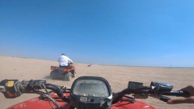 Pov, ATV arazi aracı off-road kum tepecikleri çöl yarışında toz bulutları yaratıyor. Yarışmak ve eğlenmek..