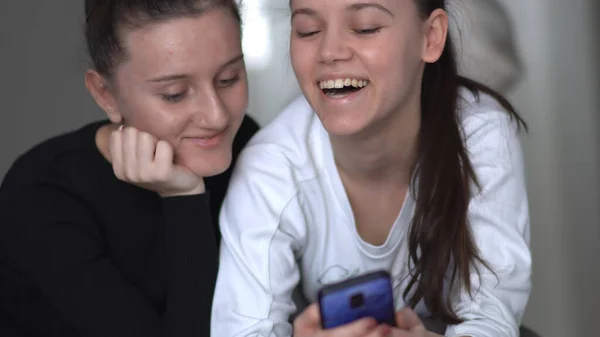 Two Young Women Sit Couch Home Looking Smartphone Screen Working — Stock Photo, Image