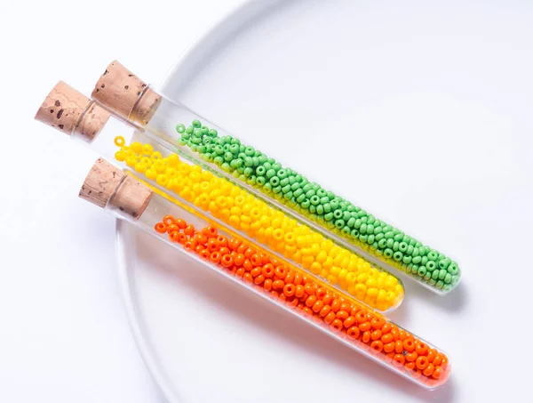 Colorfull seed beads in glass tube bottles